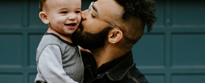 A loving father kissing his son and anticipating a bright future in Southern Nevada.